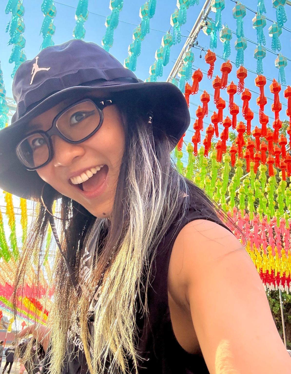 Ashley Jiang smiling beneath colorful lanterns